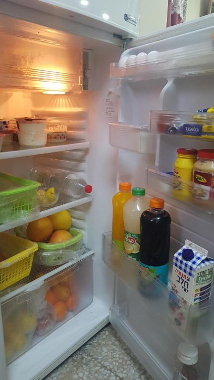 Refrigerator stocked with food for guests